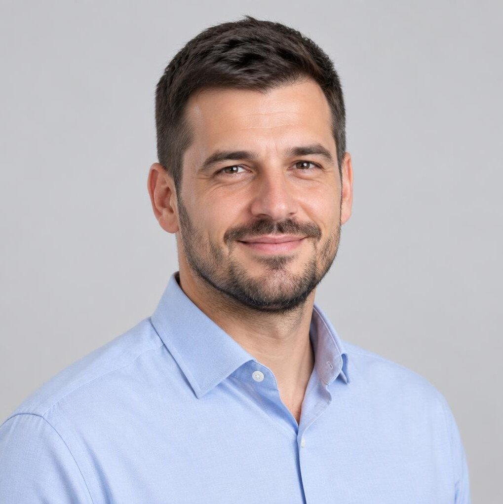 Portrait of a smiling man with short hair in business casual clothing