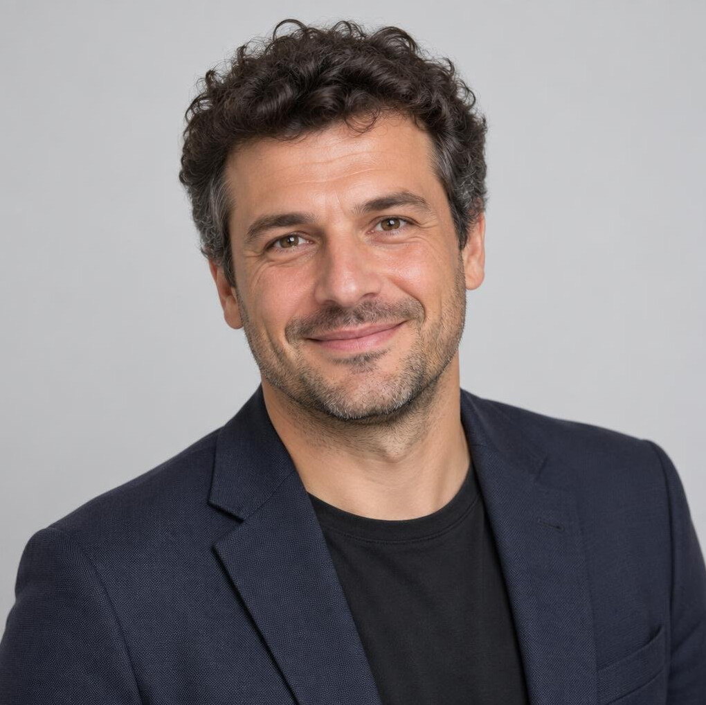 Portrait of a smiling man with short curly hair